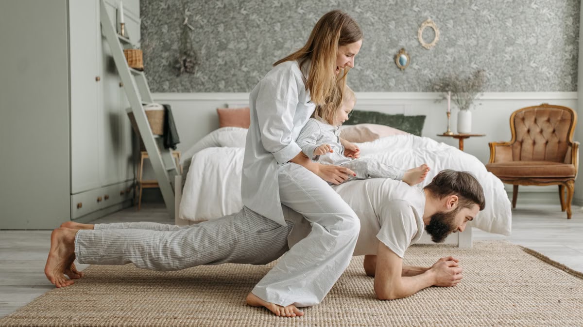 A joyful family enjoys playful bonding in a cozy bedroom, enhancing love and togetherness.